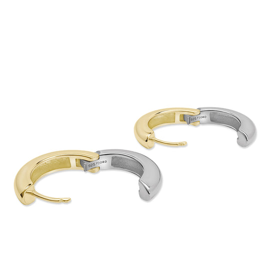 Two tone 14K gold and silver hoop earrings on a white background